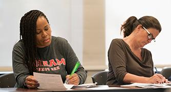 An image of two adult students in class. 